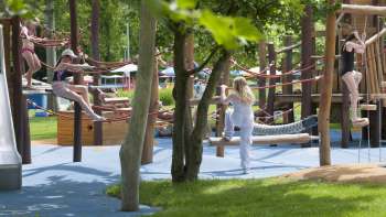  Tables et chaises colorées au restaurant de la piscine en plein air Mühleholz - idéal pour se détendre après la baignade.
