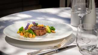 Plat de viande exquis avec légumes et fleurs au Park Hotel Sonnenhof sur la terrasse à Vaduz, Liechtenstein