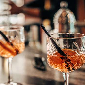 Deux verres à apéritif avec des tranches d'orange sur le bar