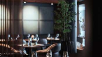 Restaurant moderne avec un intérieur stylé, des fauteuils confortables et de grandes fenêtres