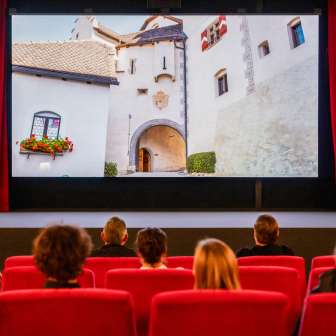 Les visiteurs de l'ancien cinéma de Vaduz regardent un film avec des images du Liechtenstein
