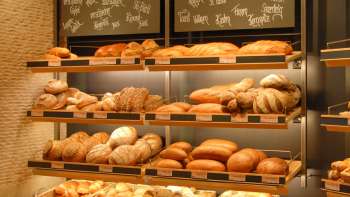Étagère remplie de pains et autres délices à la boulangerie pâtisserie Amann