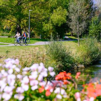 Cyclistes en route le long d'un chemin fleuri dans le Haberfeld Vaduz