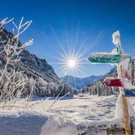 Des panneaux indicateurs enneigés et un paysage hivernal de rêve sous un soleil éclatant Steg , Liechtenstein.