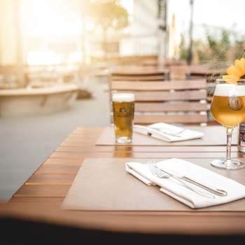 Salles de restaurant modernes avec d'élégantes tables en bois, des lampes créatives et une atmosphère chaleureuse