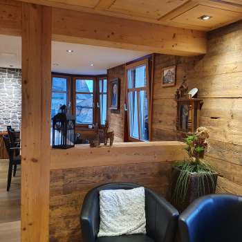 Intérieur accueillant avec des murs en bois, un coin salon élégant et un éclairage naturel