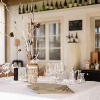 Bar décoratif dans le restaurant Vivid avec des verres et des bouteilles élégants et une ambiance lumineuse naturelle