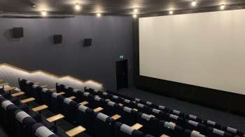 l'écran de cinéma du Skino Schaan, avec des rangées de sièges confortables au design sombre.